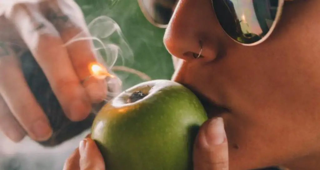 Smoking weed on an apple pipe