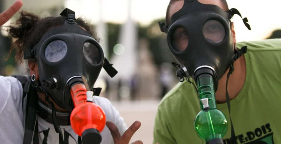 Two men with gas mask bong