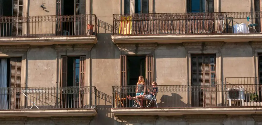 women on building balcony