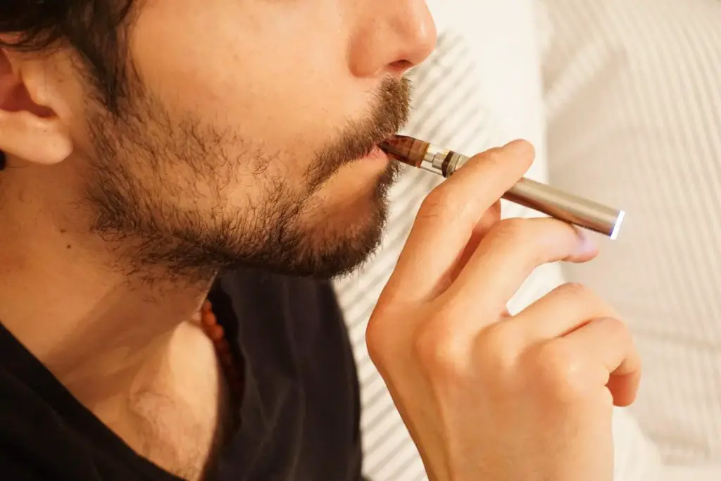 Man in black shirt smoking cigarette