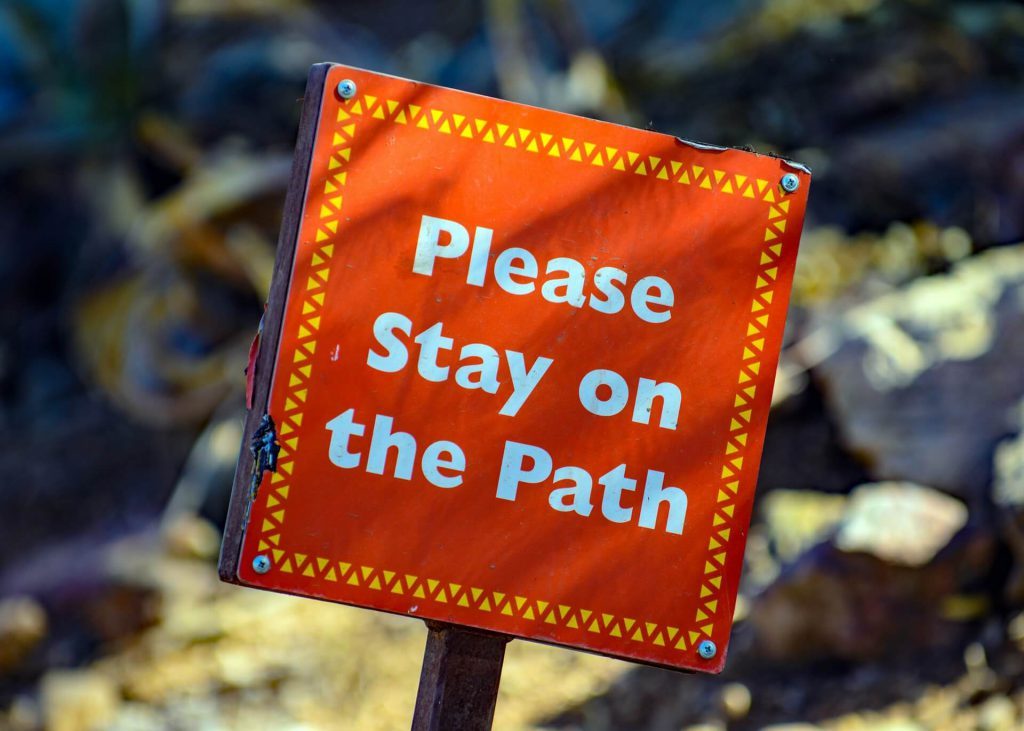 Stay on the path sign.