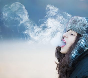 Woman with dark blue jacket with smoke